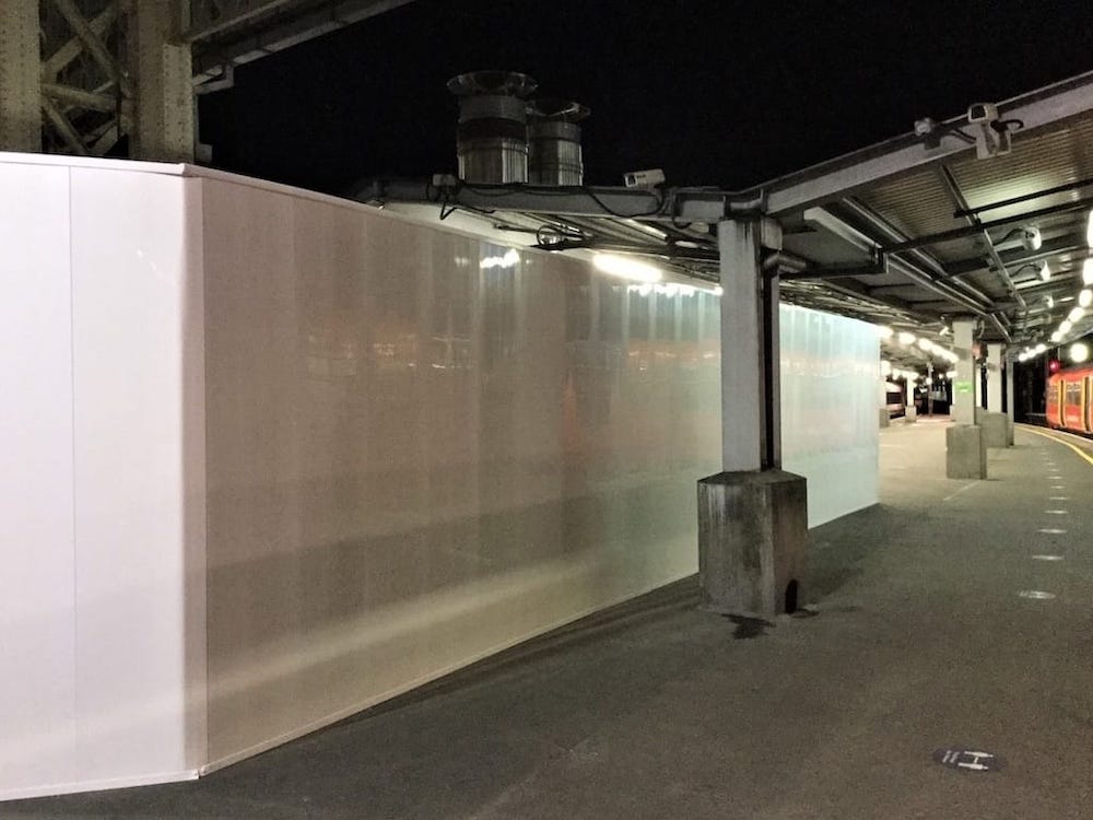 White R-11 Station Upgrade hoarding on Waterloo Station