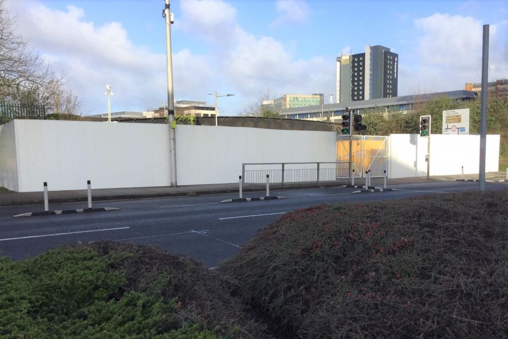 Hoarding with vehicular gates at Cardiff Bay Station